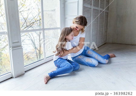 mother and daughter near the windiow 36398262
