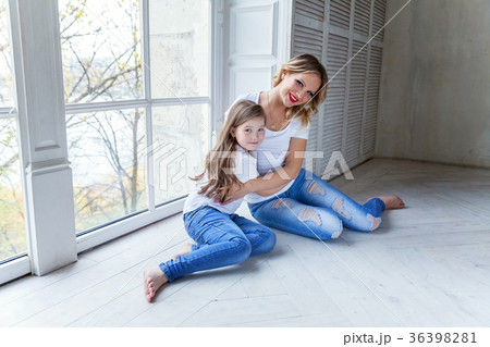 mother and daughter near the windiow 36398281