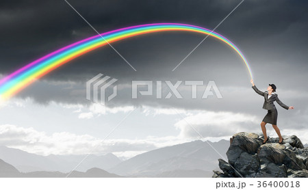 Woman catching rainbow 36400018