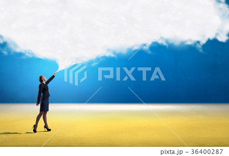Smiling businesswoman carrying big cloud in hands 36400287