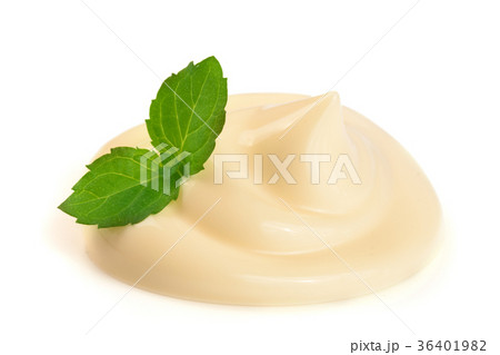 Mayonnaise swirl with a mint leaf isolated on a Mayonnaise swirl with a mint leaf isolated on a 36401982