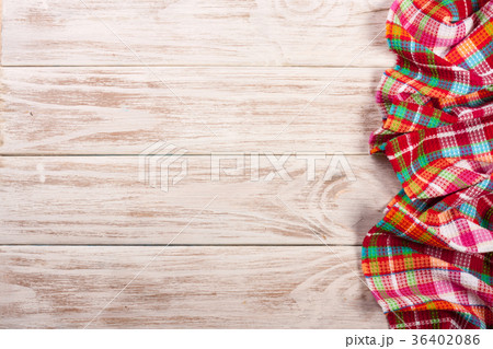 Red checkered tablecloth on a light wooden table Red checkered tablecloth on a light wooden table 36402086
