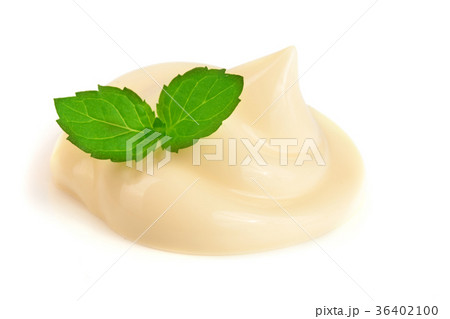 Mayonnaise swirl with a mint leaf isolated on a Mayonnaise swirl with a mint leaf isolated on a 36402100