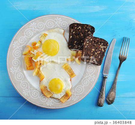 two fried eggs with pepper and two slices 36403848