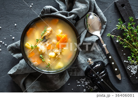Fresh fish soup in bowl on dark background Fresh fish soup in bowl on dark background 36406001
