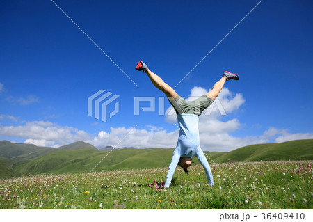 handstand woman have fun on mountain peak meadow handstand woman have fun on mountain peak meadow 36409410