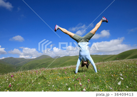 handstand woman have fun on mountain peak meadow handstand woman have fun on mountain peak meadow 36409413