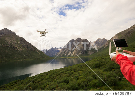 asian woman photographer flying drone outdoors asian woman photographer flying drone outdoors 36409797