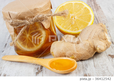 Fresh lemon, honey and ginger on wooden table Fresh lemon, honey and ginger on wooden table 36412542
