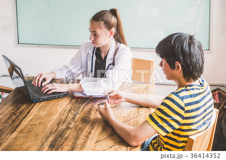 Female doctor explaining diagnosis to her patient. Female doctor explaining diagnosis to her patient. 36414352