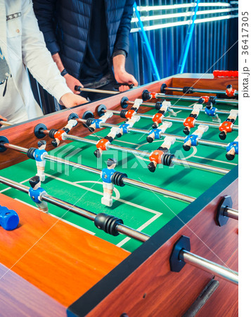 Cropped image of active people playing foosball Cropped image of active people playing foosball 36417305