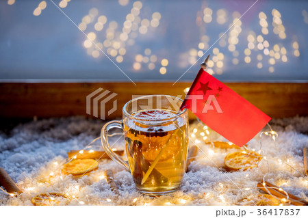 Cup of tea and flag of China on snow and fairy lights Cup of tea and flag of China on snow and fairy lights 36417837