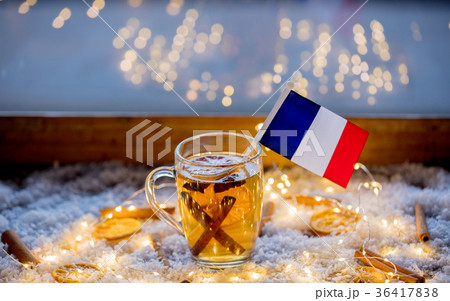 Cup of tea and flag of France on snow and fairy lights 36417838