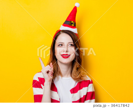 Portrait of young redhead woman in Santa Claus hat 36417842