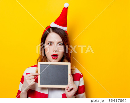 woman in Santa Claus hat with blackboard woman in Santa Claus hat with blackboard 36417862