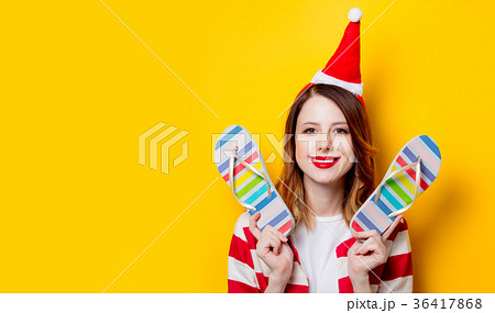 woman in Santa Claus hat with flip flops 36417868