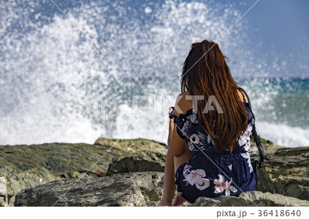 woman watching Sea Storm tempest on the coast woman watching Sea Storm tempest on the coast 36418640