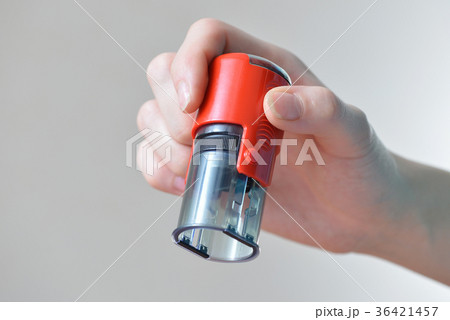 Close-up woman Hand holding rubber stamp on grey 36421457