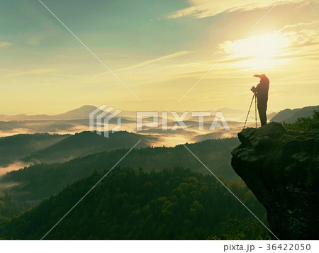 Photographer looks into the landscape and listen Photographer looks into the landscape and listen 36422050