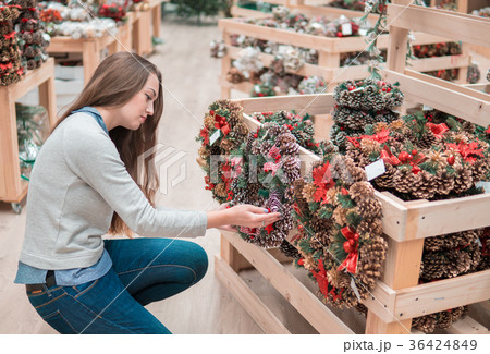 customer girl choosing Christmas decorations customer girl choosing Christmas decorations 36424849