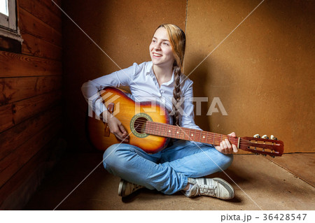 young woman playing guitar young woman playing guitar 36428547