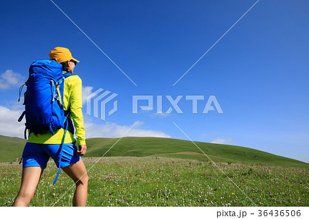 backpacking woman hiking in grassland mountain top 36436506