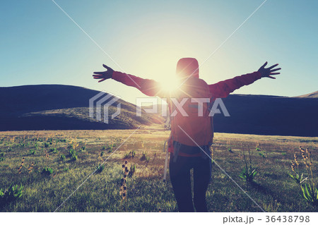 backpacking woman hiking in sunrise mountains 36438798