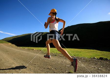 young fitness woman trail runner running outdoors young fitness woman trail runner running outdoors 36438824