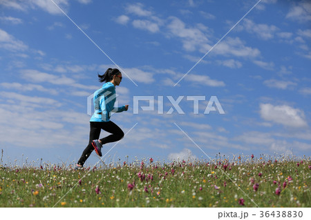 young fitness woman runner running on grassland 36438830
