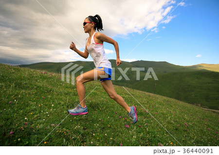 fitness woman runner running on sunset trail fitness woman runner running on sunset trail 36440091