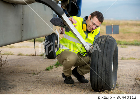 Checking aircraft's tire Checking aircraft's tire 36440112