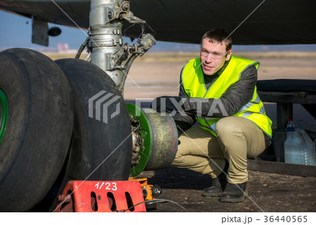 Engineer fixing aircraft's wheel Engineer fixing aircraft's wheel 36440565