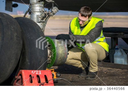 Engineer fixing aircraft's wheel Engineer fixing aircraft's wheel 36440566