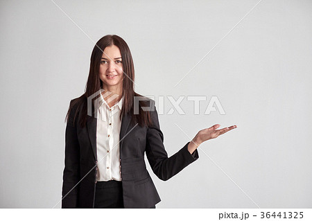 Smiling young businesswoman, showing something Smiling young businesswoman, showing something 36441325