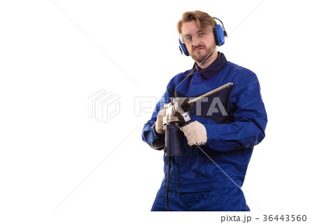 worker in glasses and headphones with a puncher  36443560