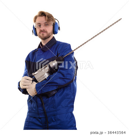 worker wearing headphones gently holds a puncher worker wearing headphones gently holds a puncher 36443564