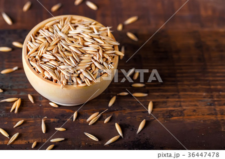 Close up oat grains in wooden bowl Close up oat grains in wooden bowl 36447478