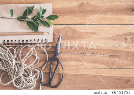 Old scissors notebook and ropes on wooden floor 36451755