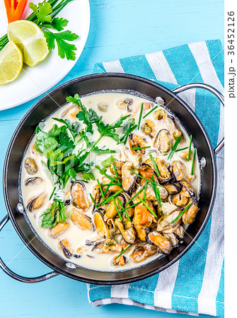 Mussels in creamy milk sauce with aromatic herbs Mussels in creamy milk sauce with aromatic herbs 36452126