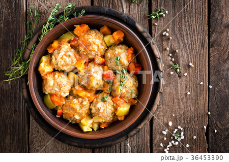 Meatballs stewed with vegetables on wooden table Meatballs stewed with vegetables on wooden table 36453390