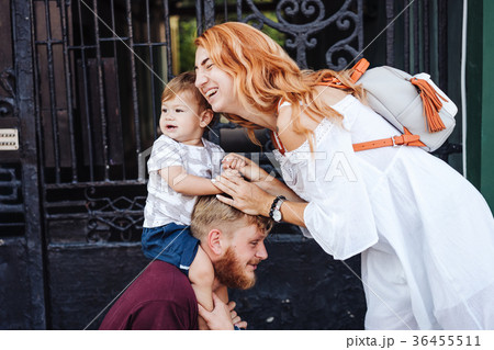 Happy parents playing with little son outdoor Happy parents playing with little son outdoor 36455511