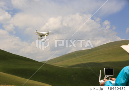 young woman flying drone outdoors young woman flying drone outdoors 36460482