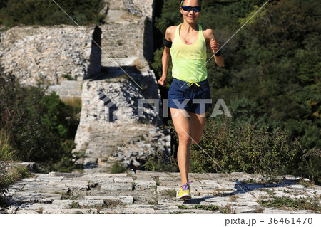 woman trail runner running on top of mountain 36461470