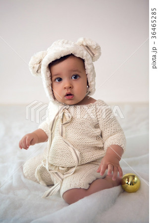 child of eight months sitting in the studio in a 36465285