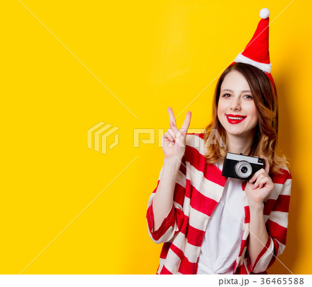 woman in Santa Claus hat with vintage camera woman in Santa Claus hat with vintage camera 36465588