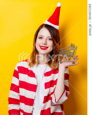 woman in Santa Claus hat with supermarket cart 36465589