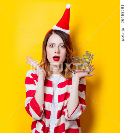 woman in Santa Claus hat with supermarket cart 36465591