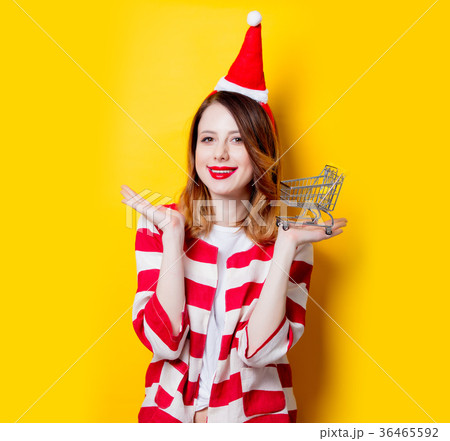 woman in Santa Claus hat with supermarket cart woman in Santa Claus hat with supermarket cart 36465592
