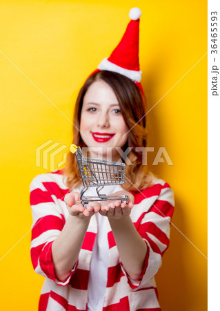 woman in Santa Claus hat with supermarket cart 36465593