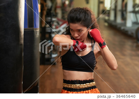 Exercising with punching bag Exercising with punching bag 36465640